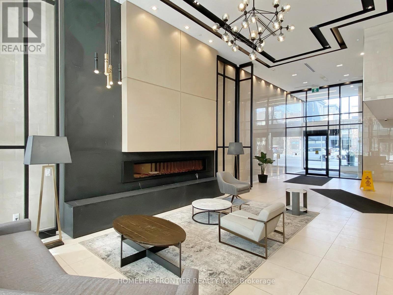 527 - 1 Belsize Drive, Toronto, ON - Indoor Photo Showing Other Room With Fireplace