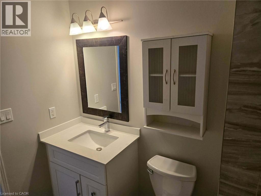 Half bath with vanity and toilet - 185 Sulmona Drive, Hamilton, ON - Indoor Photo Showing Bathroom