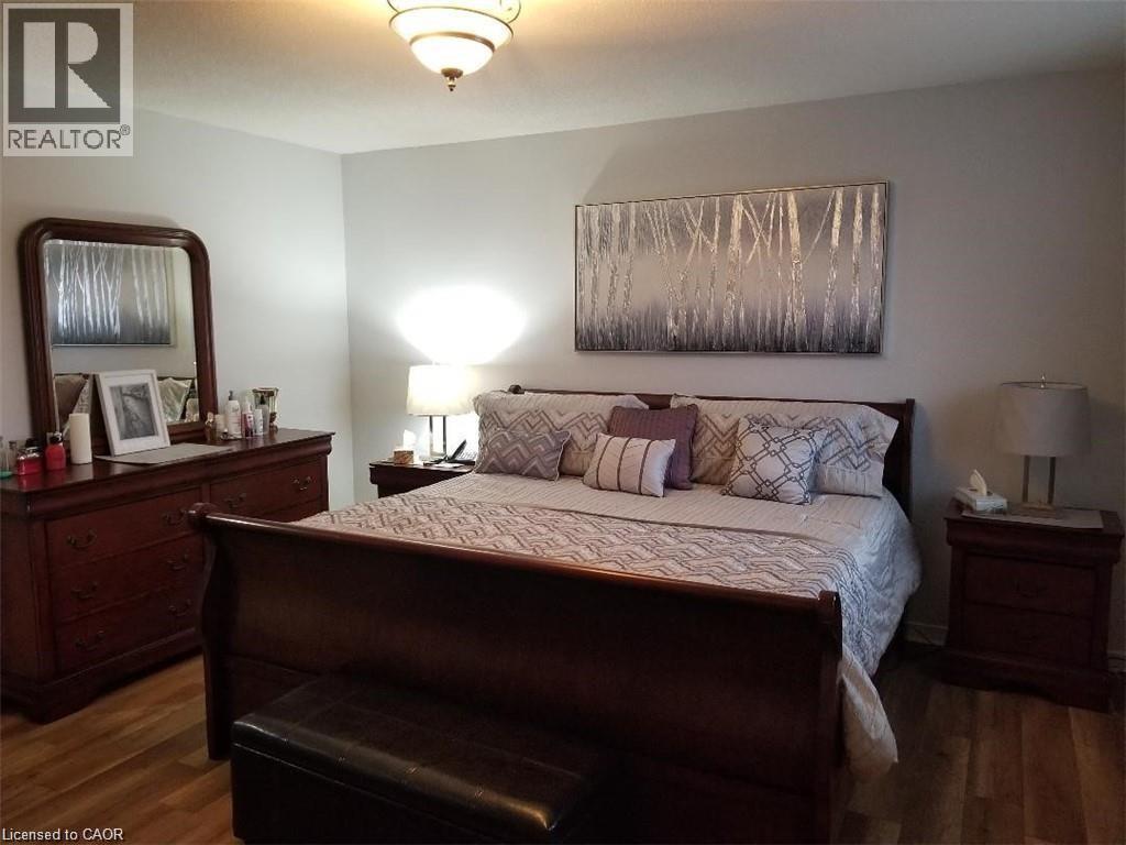 Bedroom featuring dark wood-style floors - 185 Sulmona Drive, Hamilton, ON - Indoor Photo Showing Bedroom