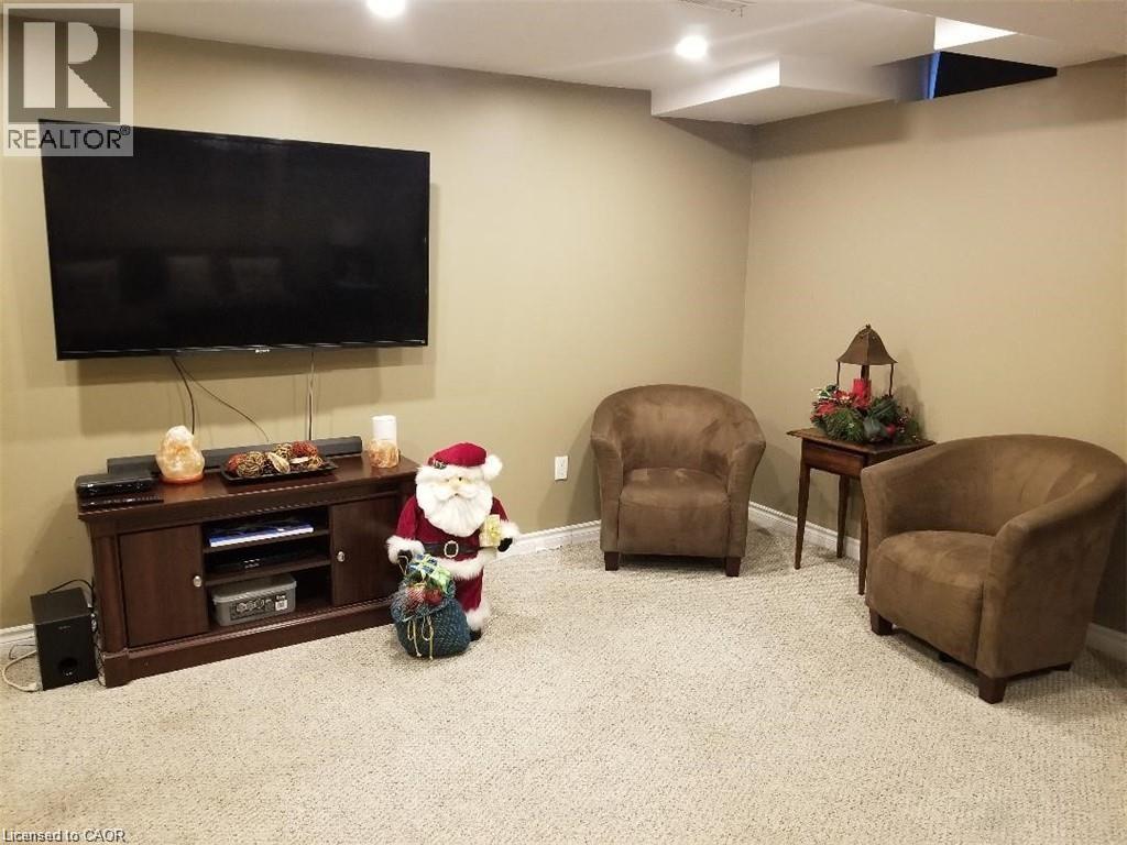 Living area featuring carpet - 185 Sulmona Drive, Hamilton, ON - Indoor Photo Showing Basement