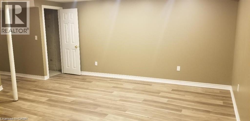 Unfurnished bedroom featuring light wood-style floors and a closet - 185 Sulmona Drive, Hamilton, ON - Indoor Photo Showing Other Room