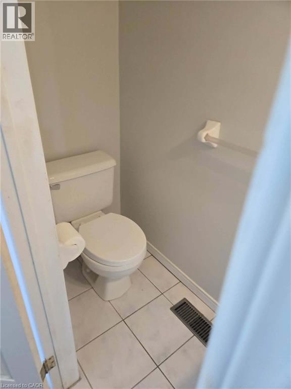 Bathroom with light tile patterned floors and toilet - 185 Sulmona Drive, Hamilton, ON - Indoor Photo Showing Bathroom