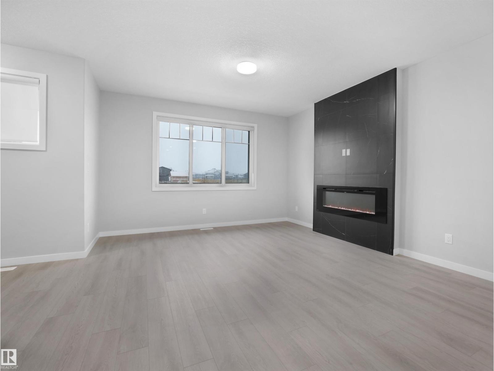 3331 Roy Brown Wy Nw, Edmonton, AB - Indoor Photo Showing Living Room With Fireplace