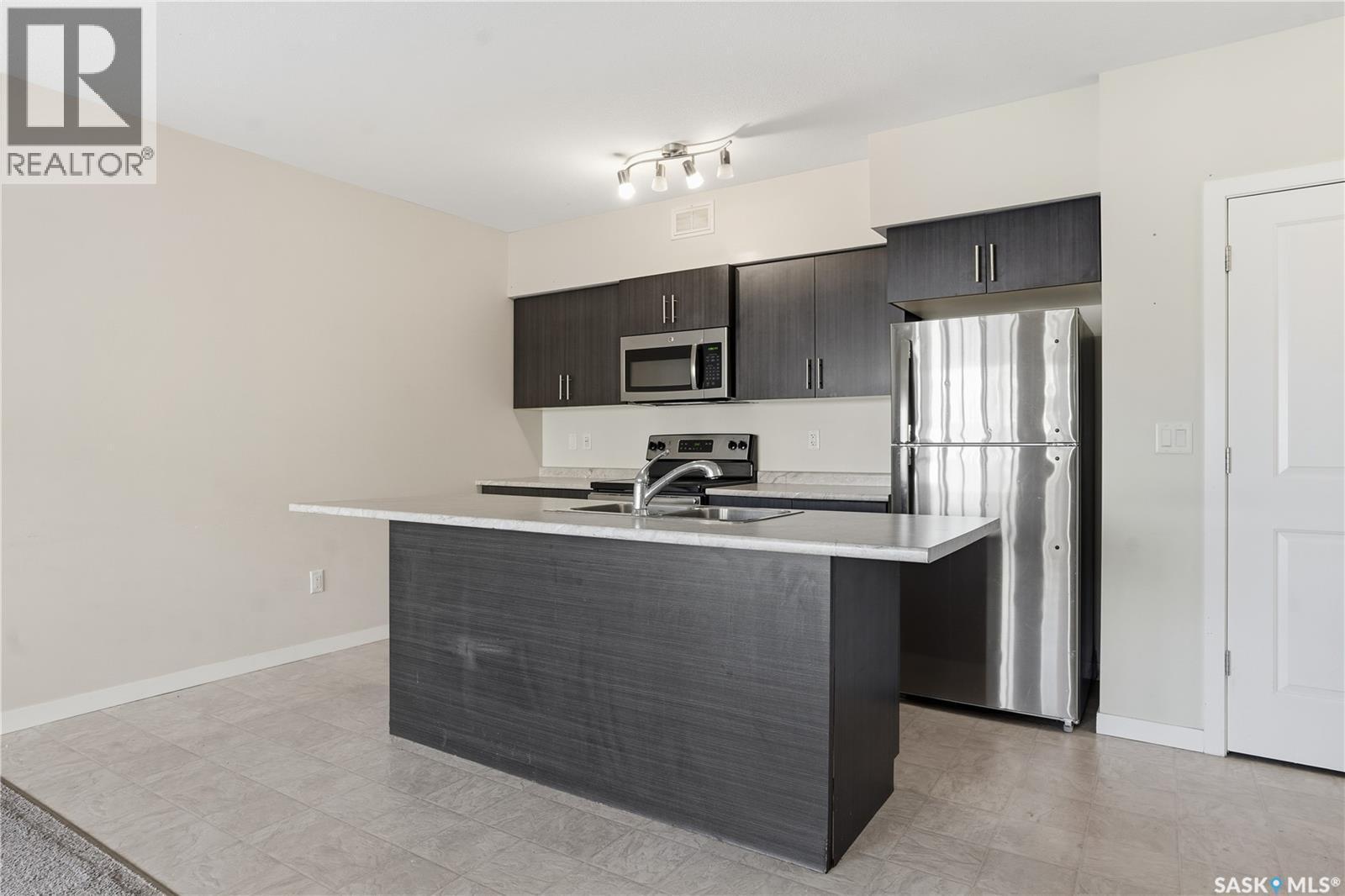 307A 3355 Green Poppy Street, Regina, SK - Indoor Photo Showing Kitchen With Double Sink