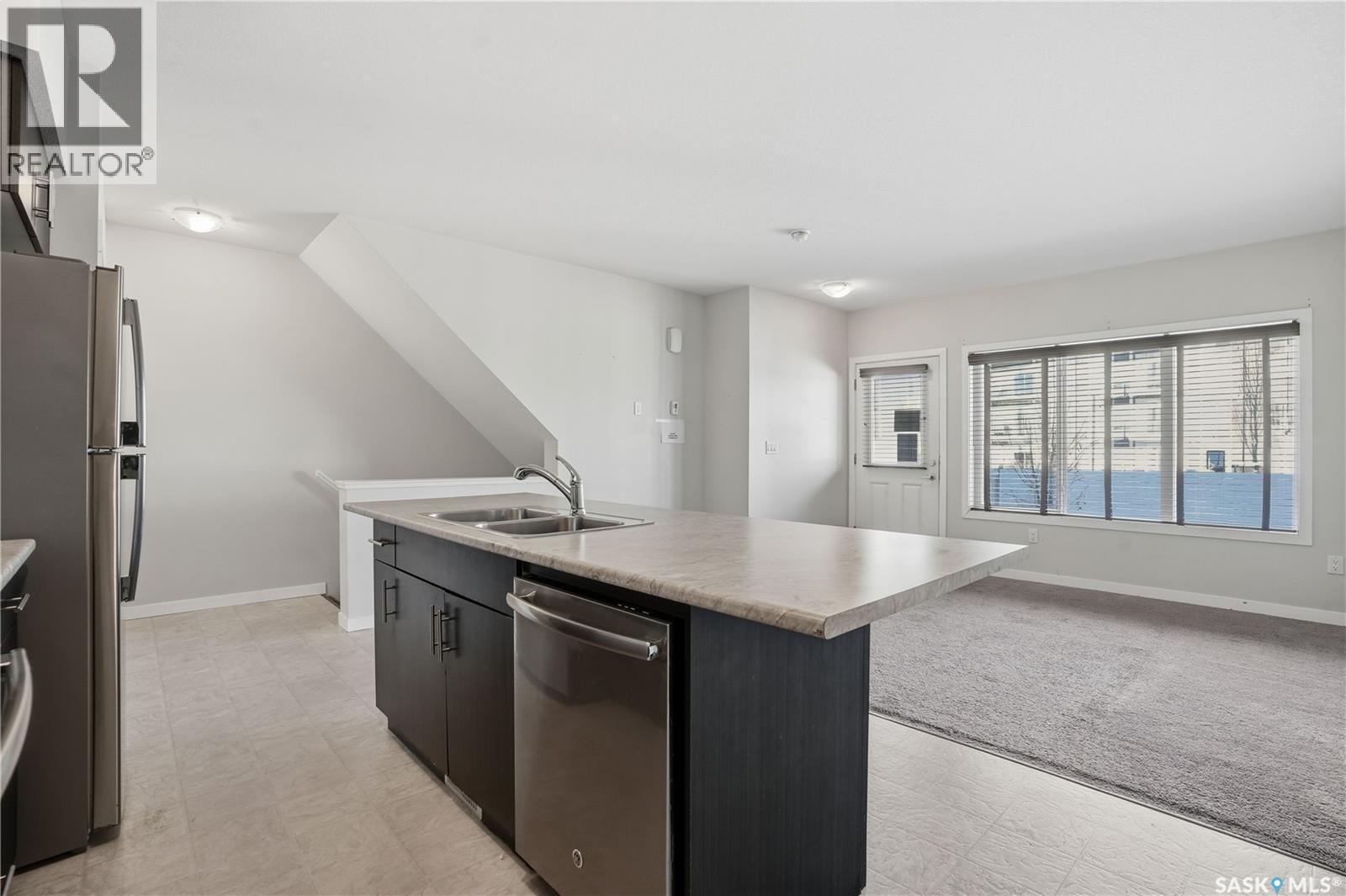 307A 3355 Green Poppy Street, Regina, SK - Indoor Photo Showing Kitchen With Double Sink