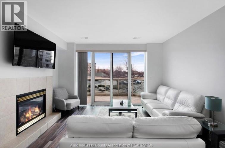 5055 Riverside Drive Unit# 201, Windsor, ON - Indoor Photo Showing Living Room With Fireplace