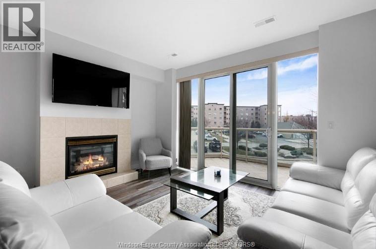 5055 Riverside Drive Unit# 201, Windsor, ON - Indoor Photo Showing Living Room With Fireplace