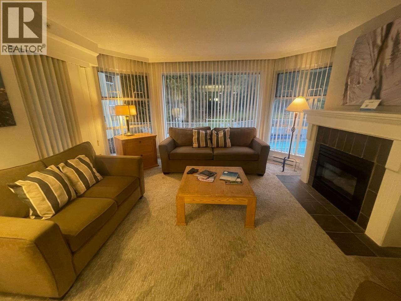 304 Week 2-4910 Spearhead Place, Whistler, BC - Indoor Photo Showing Living Room With Fireplace