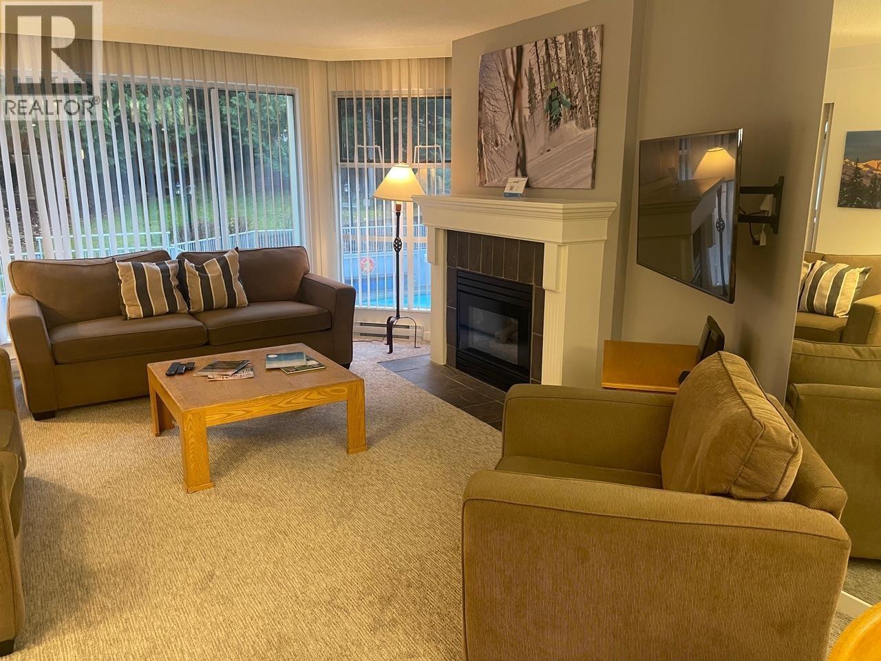 304 Week 2-4910 Spearhead Place, Whistler, BC - Indoor Photo Showing Living Room With Fireplace