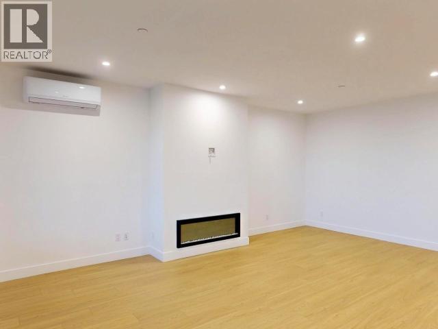 C202-6900 Burnaby Street, Powell River, BC - Indoor Photo Showing Other Room With Fireplace