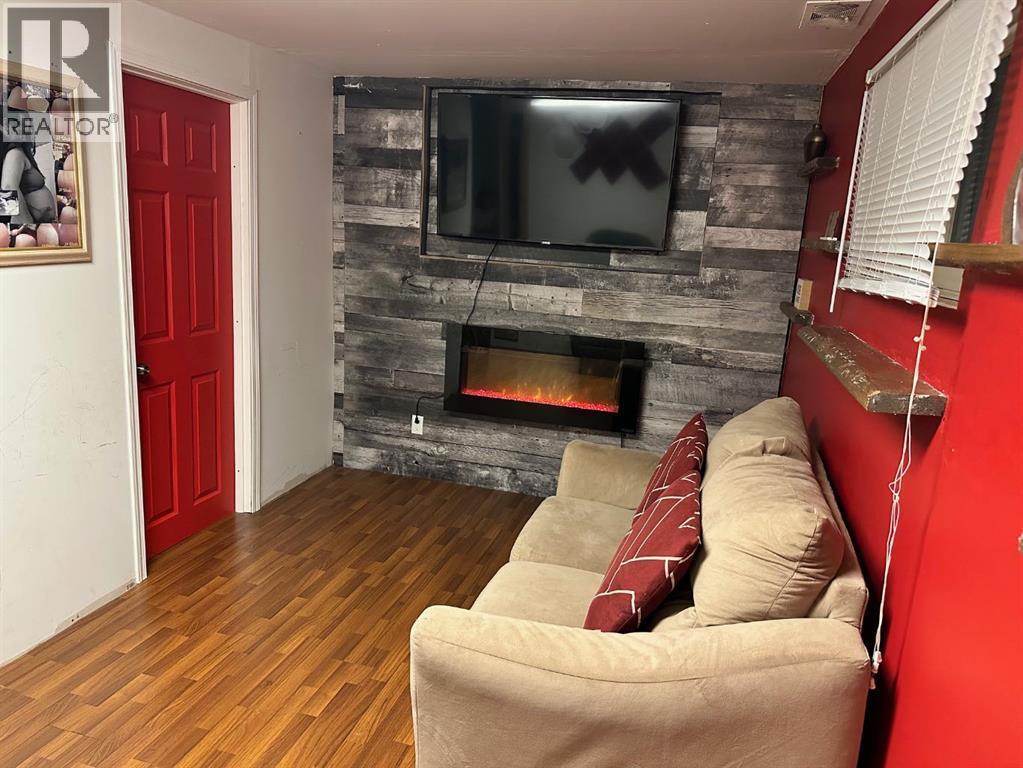 5302 50 Street, Camrose, AB - Indoor Photo Showing Living Room With Fireplace