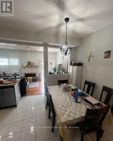 6912 Buttle Station Place, Mississauga, ON - Indoor Photo Showing Dining Room With Fireplace