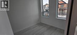 Empty room with hardwood / wood-style flooring -