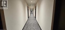 Hallway featuring carpet -