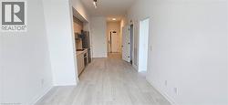 Corridor with light hardwood / wood-style flooring -