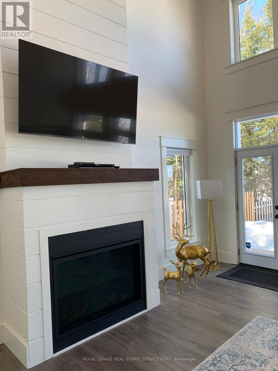 4 Crescent Road, Strong, ON - Indoor Photo Showing Living Room With Fireplace