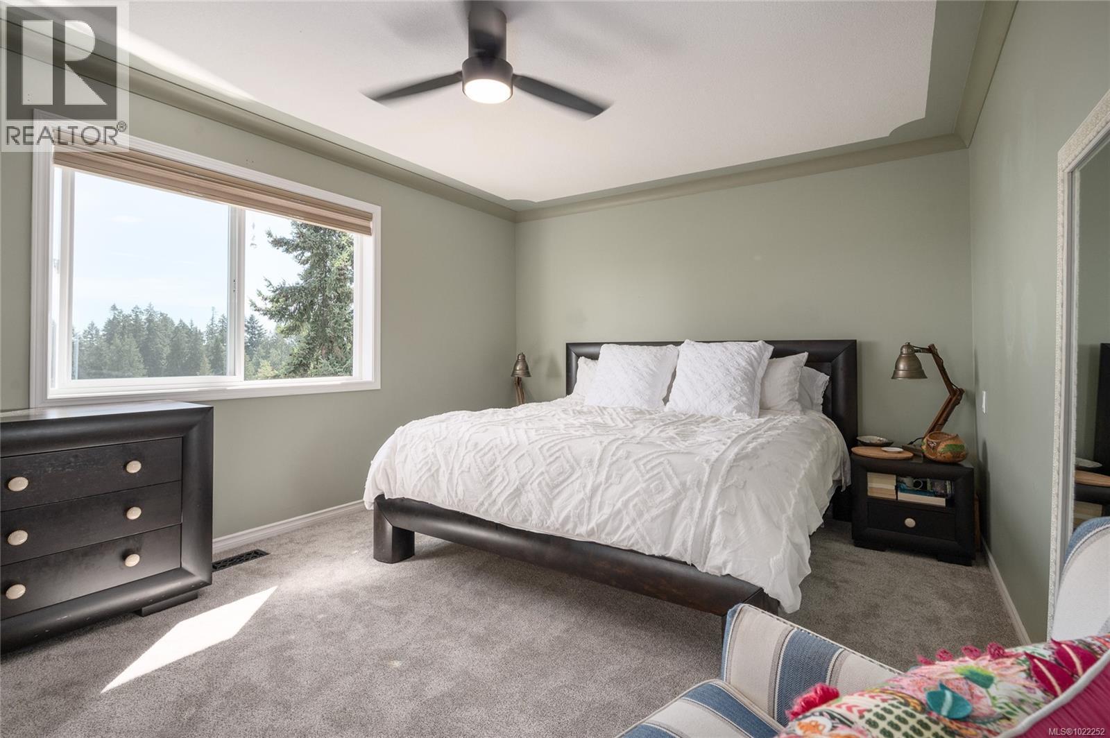 Primary bedroom...wake up refreshed with the morning sunrise. - 10091 View St, Chemainus, BC - Indoor Photo Showing Bedroom