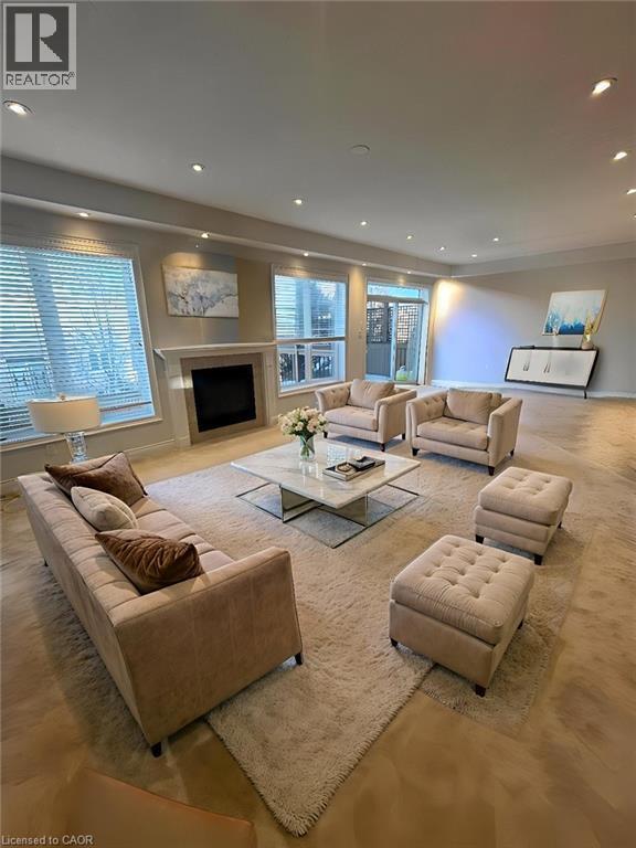Living room with a fireplace, recessed lighting, and plenty of natural light - 93 Tremaine Drive, Kitchener, ON - Indoor Photo Showing Living Room With Fireplace