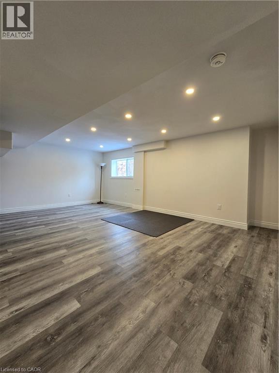 Basement with recessed lighting and wood finished floors - 93 Tremaine Drive, Kitchener, ON - Indoor