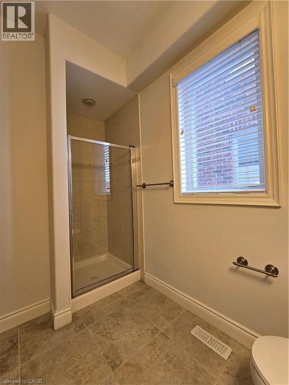 Full bath with a stall shower and light tile patterned floors - 93 Tremaine Drive, Kitchener, ON - Indoor Photo Showing Bathroom