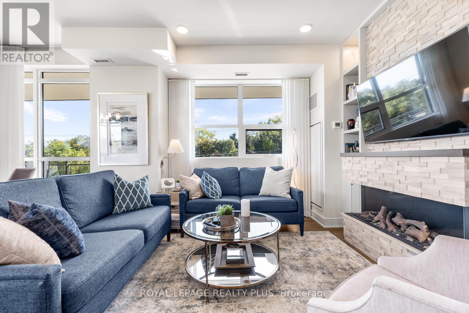 327 - 1575 Lakeshore Road W, Mississauga, ON - Indoor Photo Showing Living Room With Fireplace