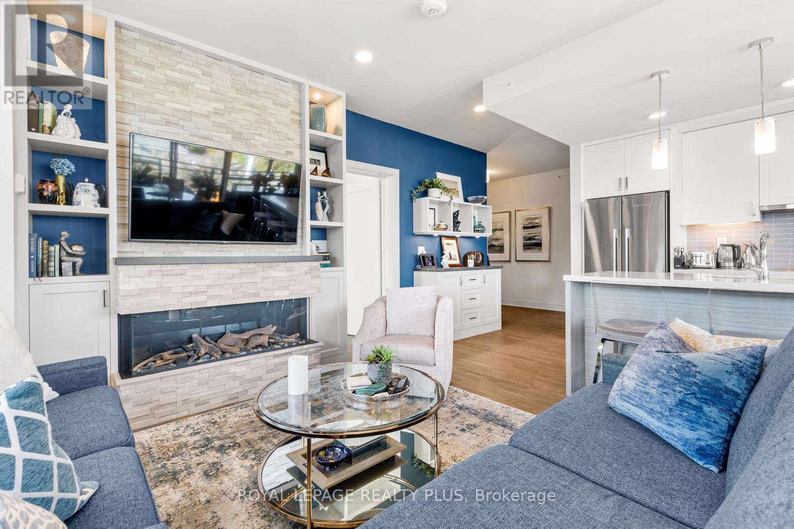 327 - 1575 Lakeshore Road W, Mississauga, ON - Indoor Photo Showing Living Room With Fireplace