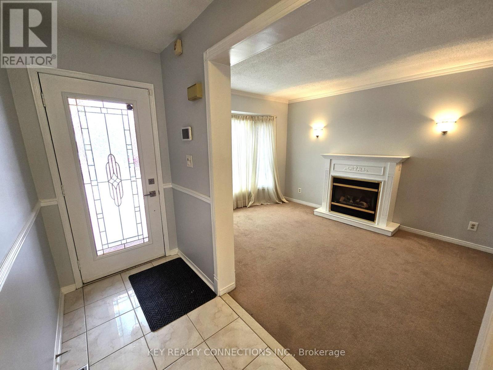 Foyer & living room - 2425 Headon Forest Drive, Burlington, ON - Indoor With Fireplace