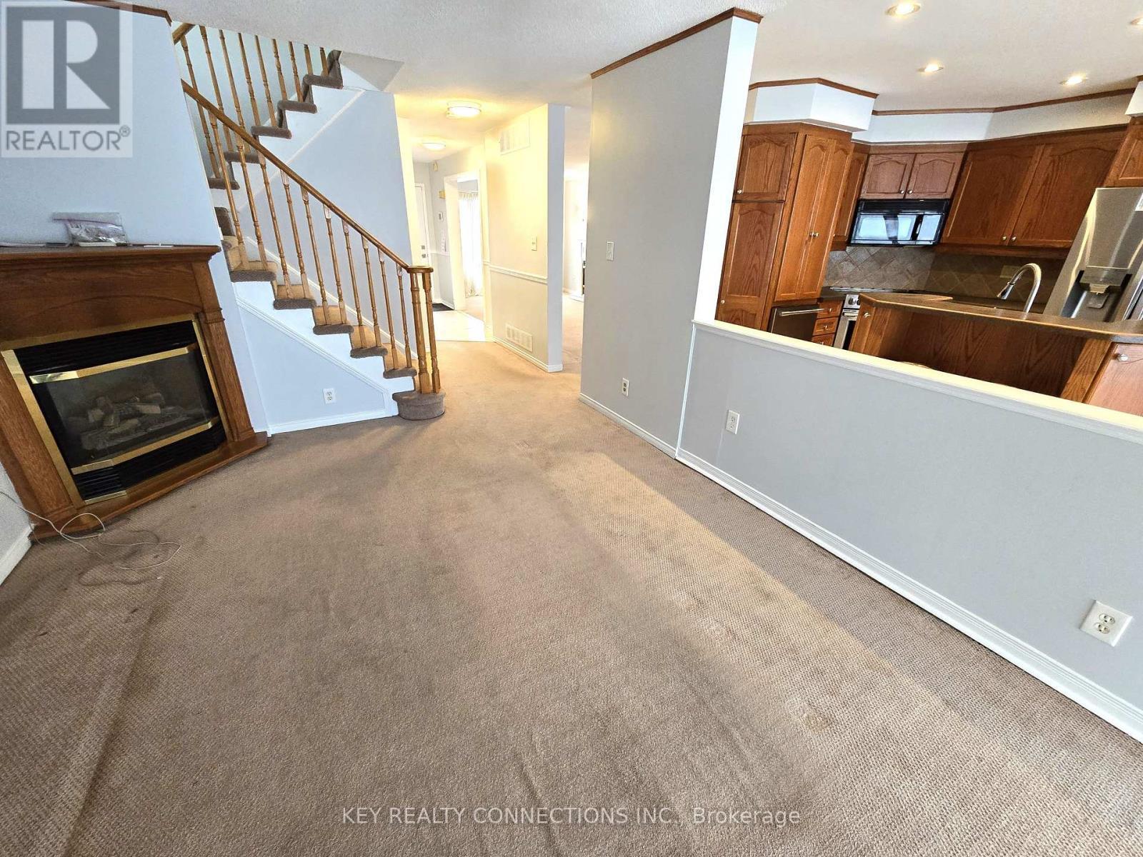 Family room & kitchen - 2425 Headon Forest Drive, Burlington, ON - Indoor With Fireplace