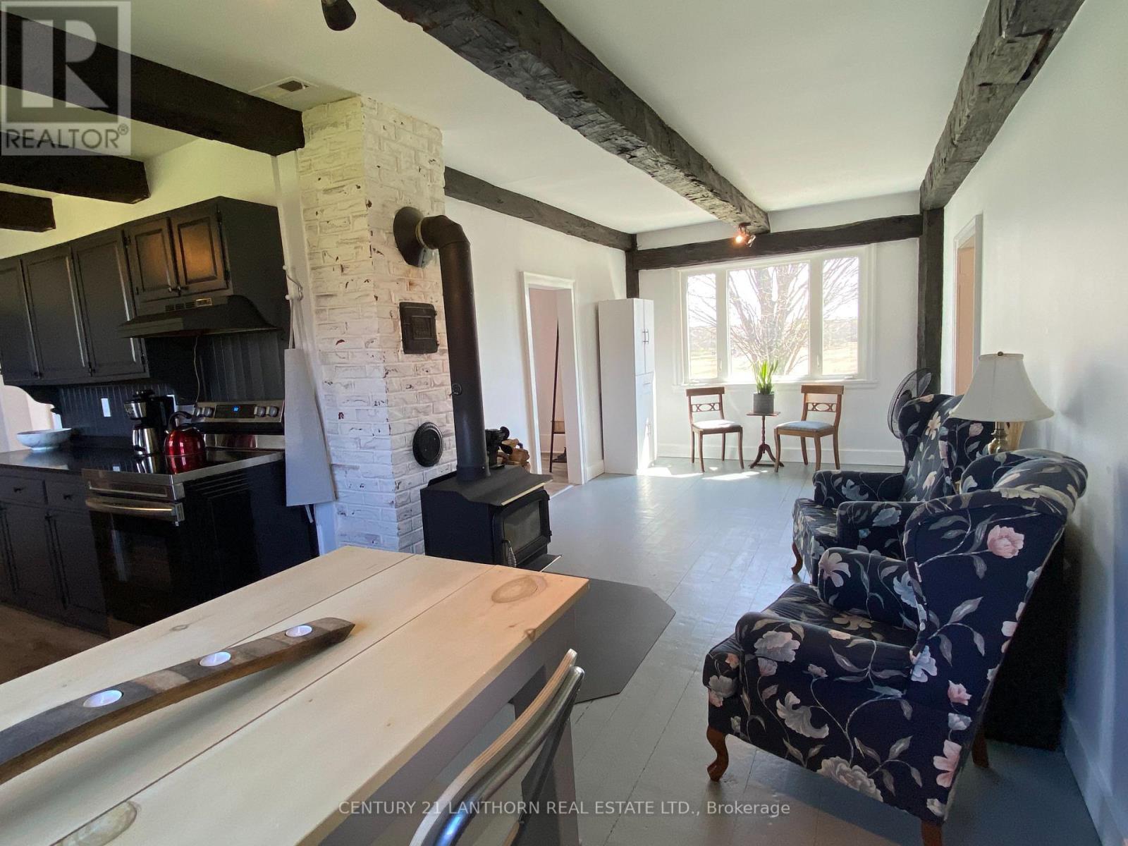 Breakfast area + cozy sitting room with wood stove - 644 County 10 Road, Prince Edward County (Hallowell Ward), ON - Indoor