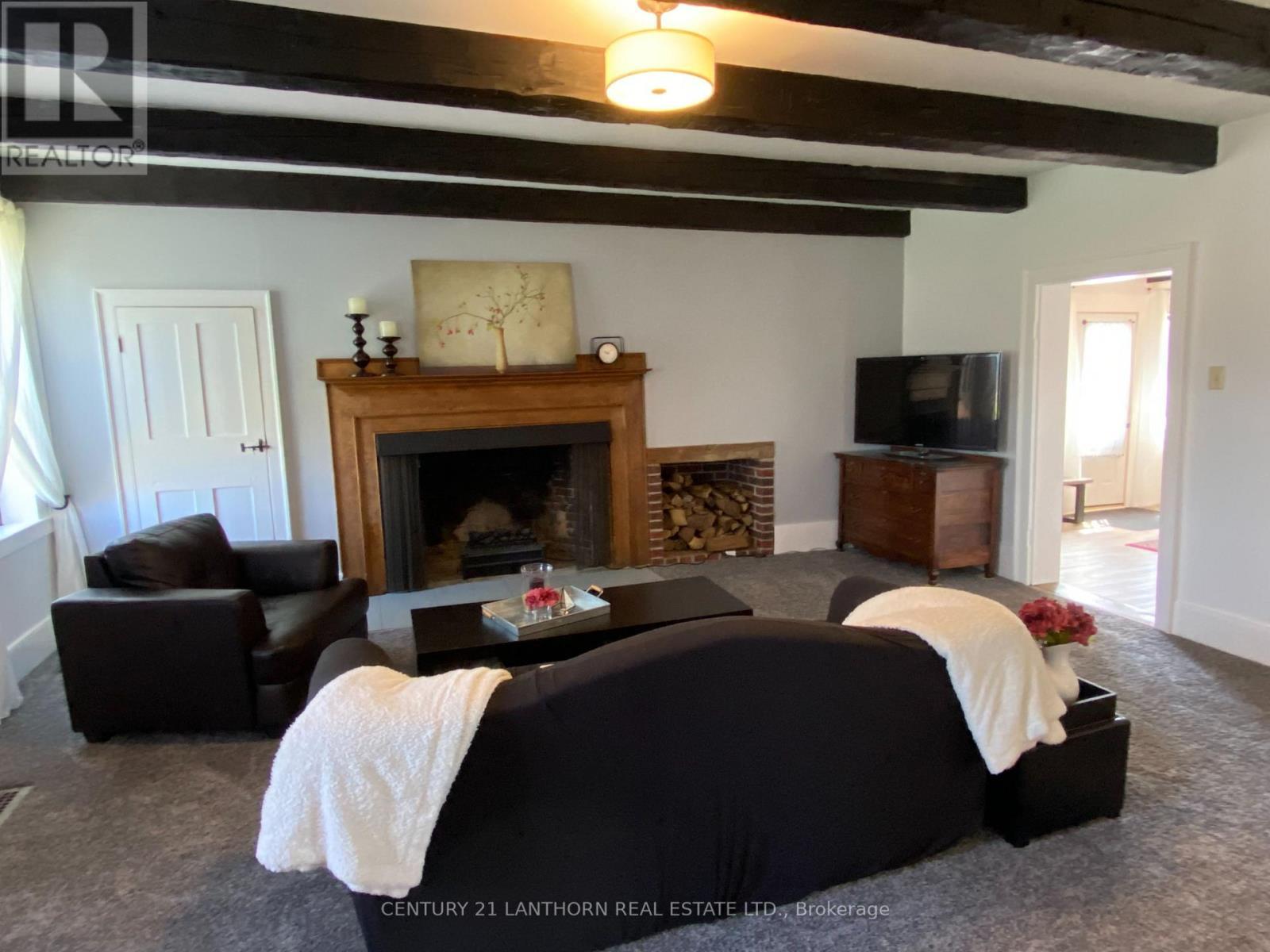 Spacious living room - 644 County 10 Road, Prince Edward County (Hallowell Ward), ON - Indoor Photo Showing Living Room With Fireplace