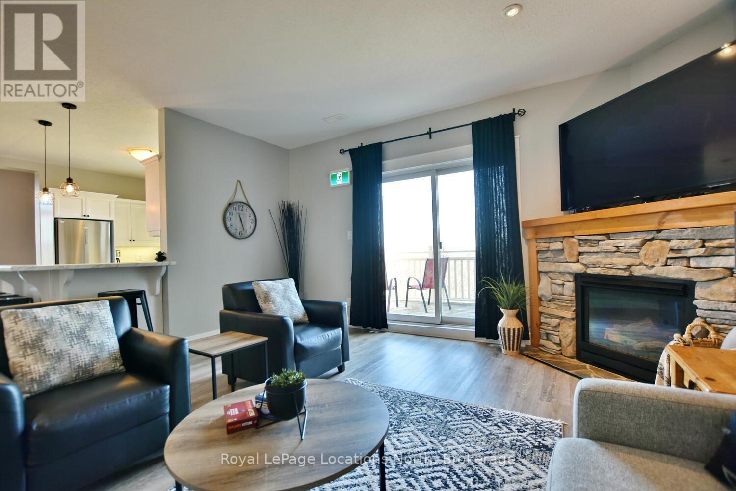 223 - 170 Snowbridge Way, Blue Mountains, ON - Indoor Photo Showing Living Room With Fireplace
