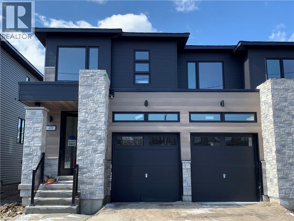 Modern home with stone siding and an attached garage - 49 Eberhardt Drive, Wasaga Beach, ON - Outdoor