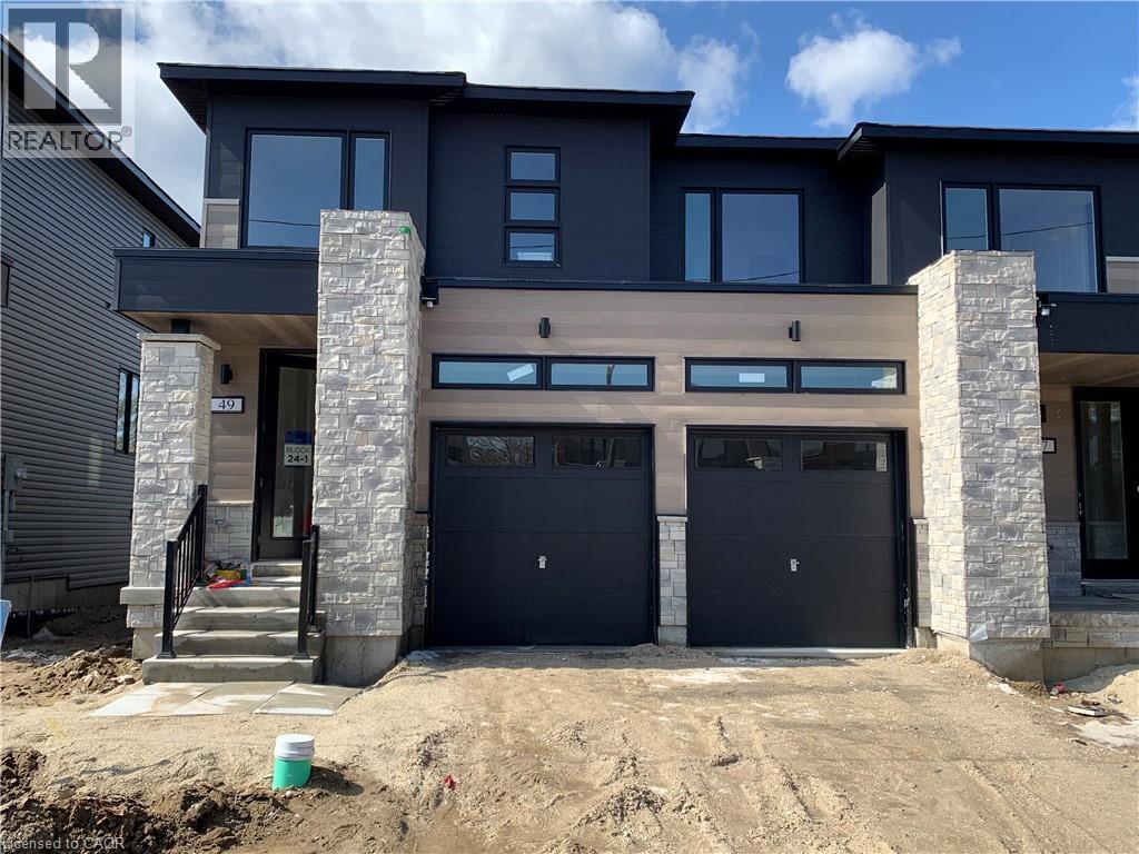 Contemporary home with stone siding, concrete driveway, and an attached garage - 49 Eberhardt Drive, Wasaga Beach, ON - Outdoor