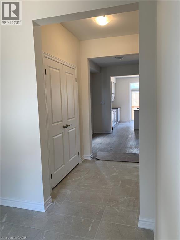 Corridor featuring baseboards and light marble finish floors - 49 Eberhardt Drive, Wasaga Beach, ON - Indoor Photo Showing Other Room