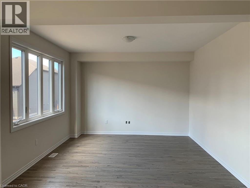 Spare room with wood finished floors and baseboards - 49 Eberhardt Drive, Wasaga Beach, ON - Indoor Photo Showing Other Room