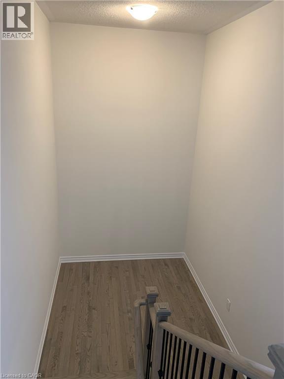 Empty room with wood finished floors and a textured ceiling - 49 Eberhardt Drive, Wasaga Beach, ON - Indoor Photo Showing Other Room