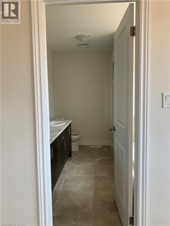 Bathroom featuring vanity and light tile patterned flooring - 49 Eberhardt Drive, Wasaga Beach, ON - Indoor Photo Showing Bathroom