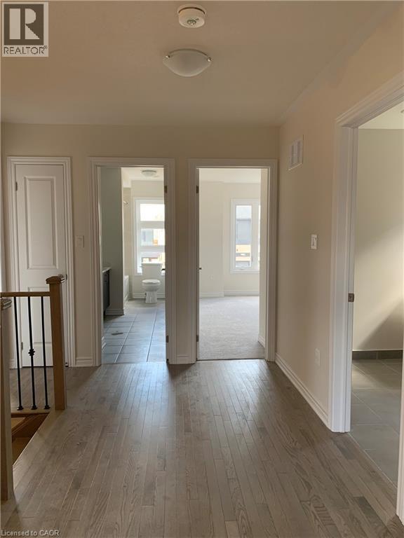 Corridor with light wood-style floors and baseboards - 49 Eberhardt Drive, Wasaga Beach, ON - Indoor Photo Showing Other Room