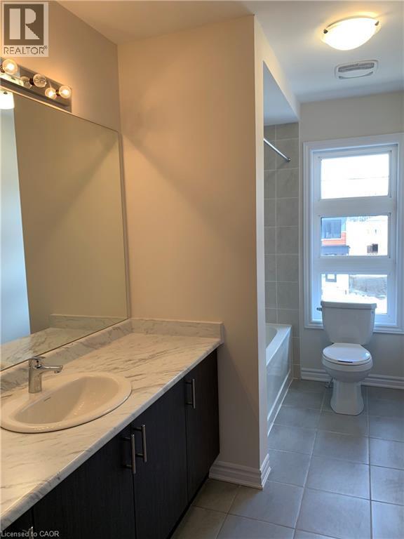 Bathroom featuring vanity, shower / bath combination, and light tile patterned floors - 49 Eberhardt Drive, Wasaga Beach, ON - Indoor Photo Showing Bathroom