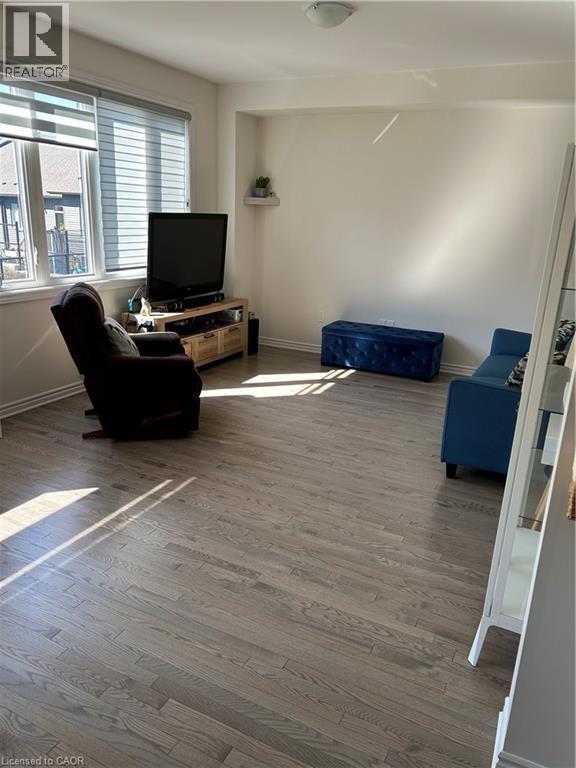 Living room featuring wood finished floors - 49 Eberhardt Drive, Wasaga Beach, ON - Indoor