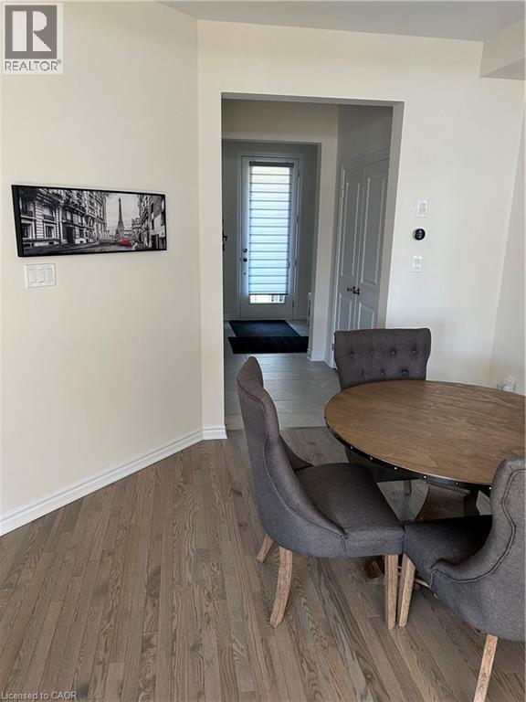Dining area with wood finished floors and baseboards - 49 Eberhardt Drive, Wasaga Beach, ON - Indoor Photo Showing Dining Room