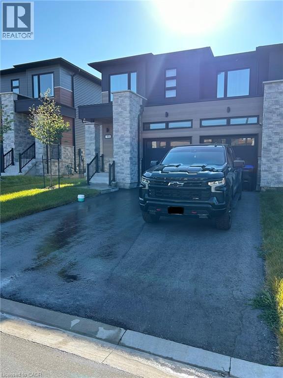 Modern home featuring stone siding, concrete driveway, stucco siding, and a garage - 49 Eberhardt Drive, Wasaga Beach, ON - Outdoor