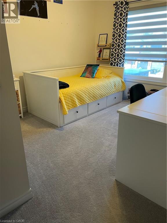 Bedroom with light carpet and a wainscoted wall - 49 Eberhardt Drive, Wasaga Beach, ON - Indoor Photo Showing Bedroom