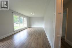 Spare room with baseboards and dark wood finished floors -