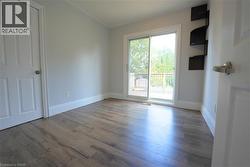 Empty room with wood finished floors and baseboards -