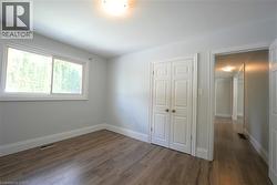 Unfurnished bedroom with dark wood-type flooring and a closet -