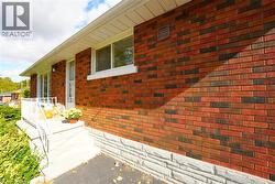 View of property exterior featuring brick siding -