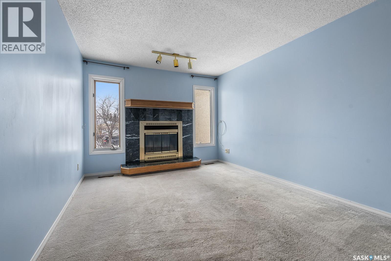 3411 Middleton Place E, Regina, SK - Indoor Photo Showing Other Room With Fireplace