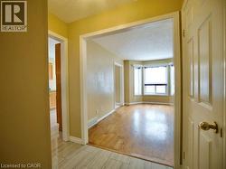 Hallway featuring light wood-type flooring and a textured ceiling -