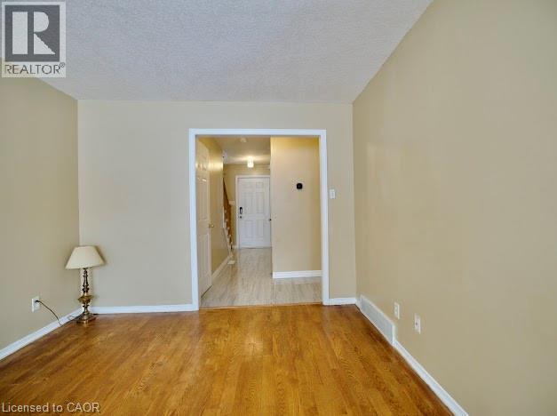 Unfurnished room featuring a textured ceiling and light wood-type flooring - 109 Beechmanor Crescent, Kitchener, ON - Indoor Photo Showing Other Room